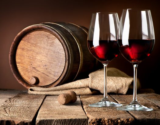 Barrel and wineglasses of red wine on a wooden table